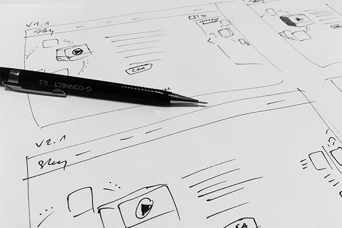Responsive website design mockup being drawn on paper